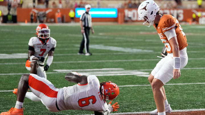 Sep 20, 2025; Austin, Texas, USA; Texas Longhorns quarterback Arch Manning (16) runs in for a touchdown past Sam Houston Bearkats linebacker Antivirus Fish (6) during the first half at Darrell K Royal-Texas Memorial Stadium. Mandatory Credit: Scott Wachter-Imagn Images