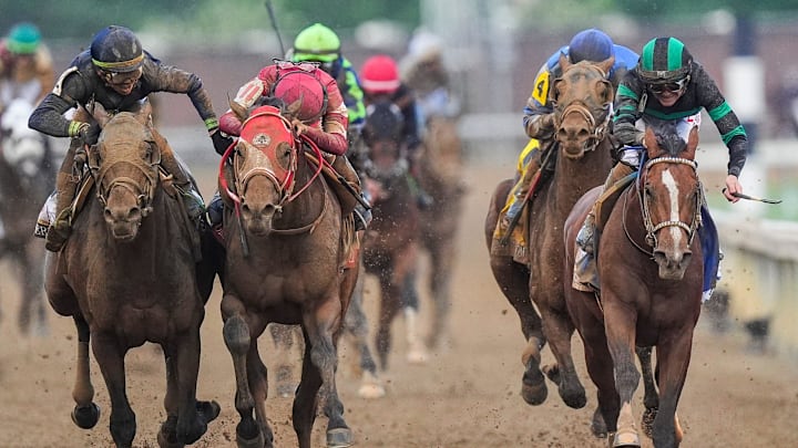 Near the finish line, jockey Tyler Gaffalione, left, and Forever Young's jockey Ryusei Sakai crowd after the two horses bumped and Mystik Dan with jockey Brian J. Hernandez, right, won the 2024 Kentucky Derby at Churchill Downs Saturday, May 4, 2024 in Louisville, Kentucky.