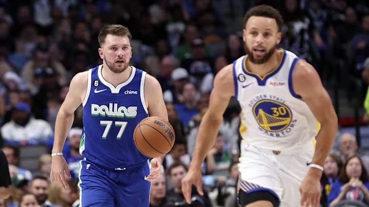 Dallas Mavericks guard Luka Doncic (77) dribbles as Golden State Warriors guard Stephen Curry (30) runs upcourt during the second half at American Airlines Center. Mandatory Credit: Kevin Jairaj-Imagn Images