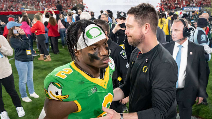 Oregon head coach Dan Lanning, right greets inside linebacker Jeffrey Bassa as the team walks off the field as the Oregon Ducks face the Ohio State Buckeyes Wednesday, Jan. 1, 2025, in the quarterfinal of the College Football Playoff at the Rose Bowl in Pasadena, Calif.