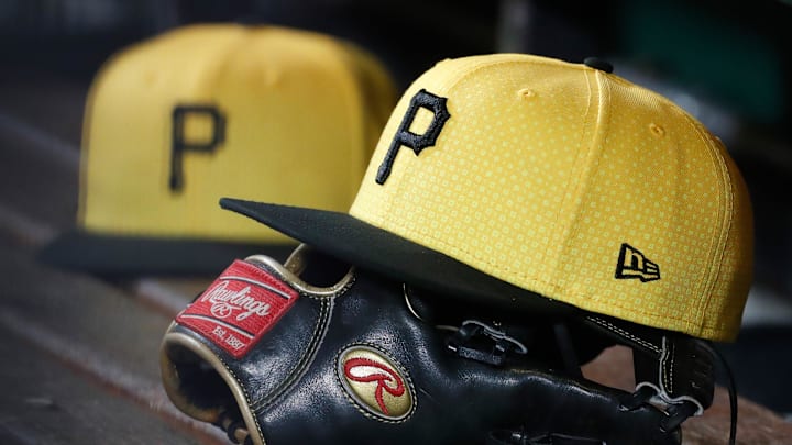 Sep 16, 2023; Pittsburgh, Pennsylvania, USA;  Pittsburgh Pirates hats and gloves in the dugout against the New York Yankees during the sixth inning at PNC Park. Mandatory Credit: Charles LeClaire-Imagn Images