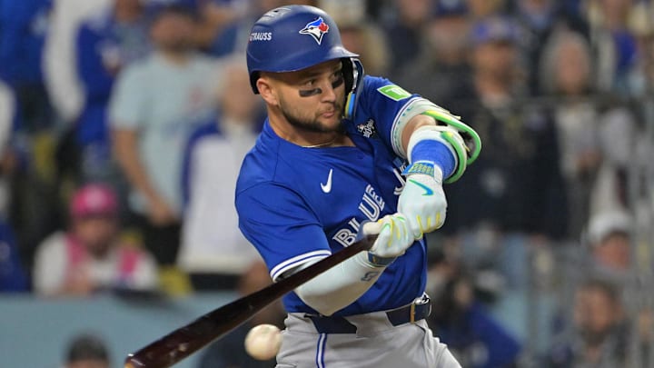 Oct 27, 2025; Los Angeles, California, USA; Toronto Blue Jays second baseman Bo Bichette (11) hits an RBI single against the Los Angeles Dodgers in the seventh inning during game three of the 2025 MLB World Series at Dodger Stadium. Mandatory Credit: Jayne Kamin-Oncea-Imagn Images Oct 27, 2025; Los Angeles, California, USA; Toronto Blue Jays second baseman Bo Bichette (11) hits an RBI single against the Los Angeles Dodgers in the seventh inning during game three of the 2025 MLB World Series at Dodger Stadium. Mandatory Credit: Jayne Kamin-Oncea-Imagn Images