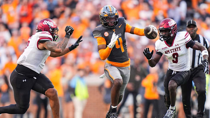 Tennessee defensive back Ty Redmond (4) tries to get through the New Mexico State offense after intercepting the ball during an an NCAA college football game on November 15, 2025, in Knoxville, Tenn.