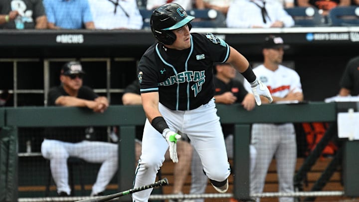 Jun 15, 2025; Omaha, Neb, USA; Coastal Carolina Chanticleers catcher Caden Bodine (17) reaches on an infield error by the Oregon State Beavers during the first inning at Charles Schwab Field. Jun 15, 2025; Omaha, Neb, USA; Coastal Carolina Chanticleers catcher Caden Bodine (17) reaches on an infield error by the Oregon State Beavers during the first inning at Charles Schwab Field.