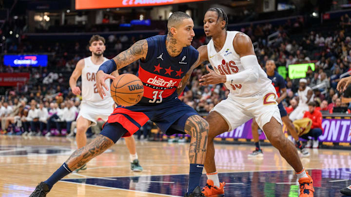 Oct 26, 2024; Washington, District of Columbia, USA; Washington Wizards forward Kyle Kuzma (33) dribbles the ball against Cleveland Cavaliers forward Isaac Okoro (35) during the second quarter at Capital One Arena.