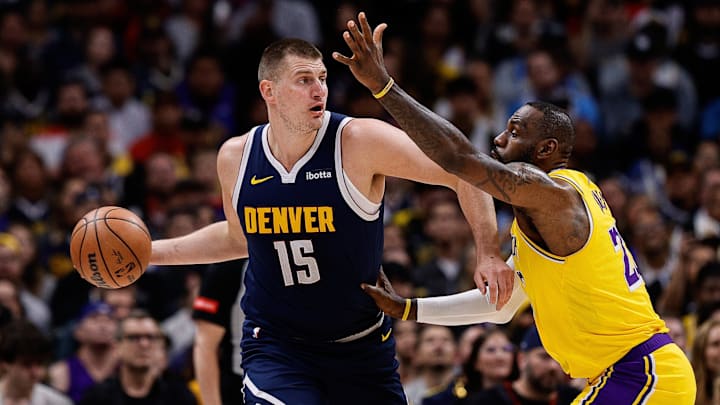Apr 29, 2024; Denver, Colorado, USA; Denver Nuggets center Nikola Jokic (15) controls the ball under pressure from Los Angeles Lakers forward LeBron James (23) in the first quarter during game five of the first round for the 2024 NBA playoffs at Ball Arena. Mandatory Credit: Isaiah J. Downing-Imagn Images Apr 29, 2024; Denver, Colorado, USA; Denver Nuggets center Nikola Jokic (15) controls the ball under pressure from Los Angeles Lakers forward LeBron James (23) in the first quarter during game five of the first round for the 2024 NBA playoffs at Ball Arena. Mandatory Credit: Isaiah J. Downing-Imagn Images