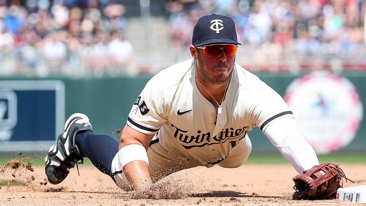 May 25, 2025; Minneapolis, Minnesota, USA; Minnesota Twins first baseman Ty France (13) dives to first base for a force out on a ball hit by Kansas City Royals first baseman Vinnie Pasquantino (9) during the eighth inning at Target Field. Mandatory Credit: Matt Krohn-Imagn Images
