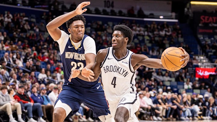 Jan 14, 2026; New Orleans, Louisiana, USA;  Brooklyn Nets guard/forward Drake Powell (4) dribbles against New Orleans Pelicans center Derik Queen (22) during the first half at Smoothie King Center. Mandatory Credit: Stephen Lew-Imagn Images