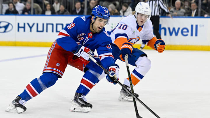 Jan 29, 2026; New York, New York, USA;  New York Islanders right wing Simon Holmstrom (10) defends against New York Rangers defenseman Matthew Robertson (29) during the third period at Madison Square Garden. Mandatory Credit: Dennis Schneidler-Imagn Images