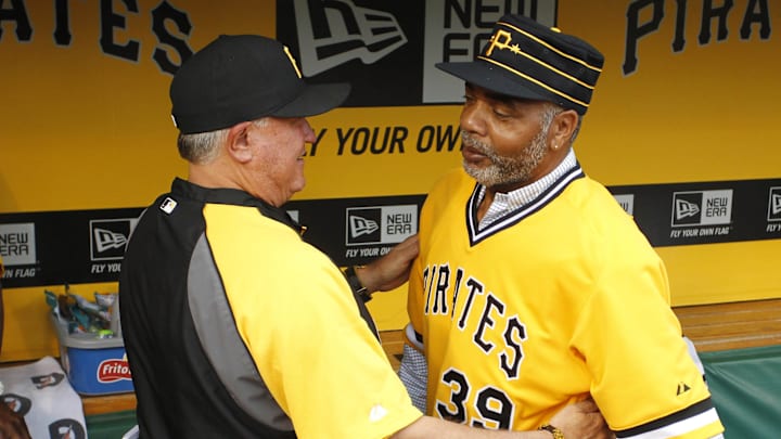 May 21, 2014; Pittsburgh, PA, USA; Pittsburgh Pirates manager Clint Hurdle (left) greets Pirates former right fielder Dave Parker (39) in the dugout before playing the Baltimore Orioles at PNC Park. The Pirates won 9-8. Mandatory Credit: Charles LeClaire-Imagn Images