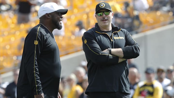 Sep 22, 2024; Pittsburgh, Pennsylvania, USA;  Pittsburgh Steelers head coach Mike Tomlin (left) and offensive coordinator Arthur Smith (right) talk on the field before the game against the Los Angeles Chargers at Acrisure Stadium. Mandatory Credit: Charles LeClaire-Imagn Images