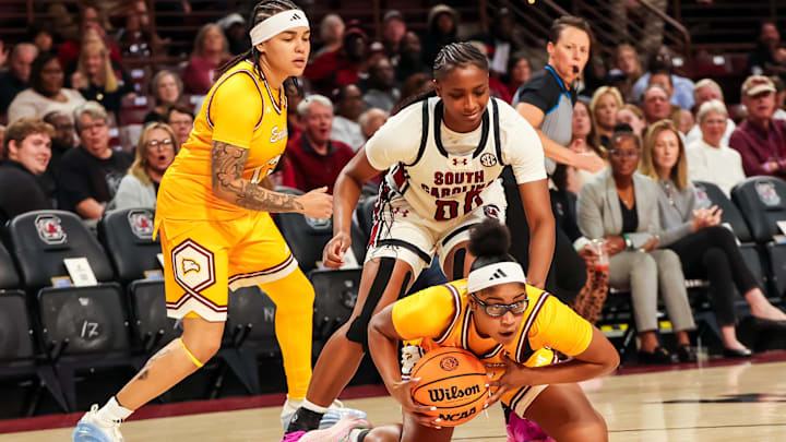Nov 19, 2025; Columbia, South Carolina, USA; Winthrop Eagles guard Madison Ruff (3) gathers the ball in front of South Carolina Gamecocks guard Ta'Niya Latson (00) in the first half at Colonial Life Arena. Mandatory Credit: Jeff Blake-Imagn Images