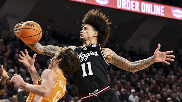 Texas A&M Aggies forward Andersson Garcia (11) grabs the rebound over Tennessee Volunteers forward Cade Phillips (12) during the second half at Reed Arena.