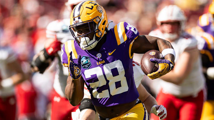 Jan 1, 2024; Tampa, FL, USA; LSU Tigers running back Kaleb Jackson (28) rushes for a touchdown during the first half against the Wisconsin Badgers at Raymond James Stadium. Mandatory Credit: Matt Pendleton-Imagn Images