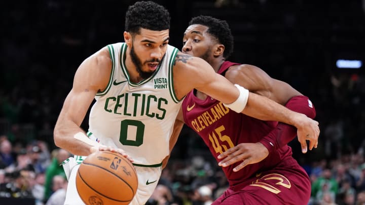 Dec 12, 2023; Boston, Massachusetts, USA; Boston Celtics forward Jayson Tatum (0) drives the ball against Cleveland Cavaliers guard Donovan Mitchell (45) in the second half at TD Garden. Mandatory Credit: David Butler II-USA TODAY Sports