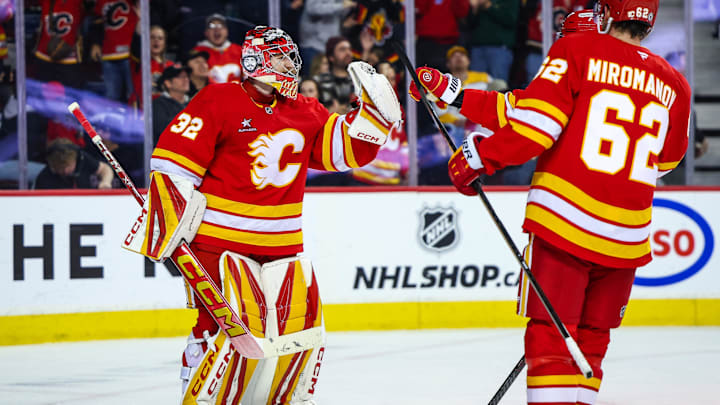 Nov 15, 2024; Calgary, Alberta, CAN; Calgary Flames goaltender Dustin Wolf (32) celebrate win with teammates after defeating Nashville Predators at Scotiabank Saddledome. Mandatory Credit: Sergei Belski-Imagn Images