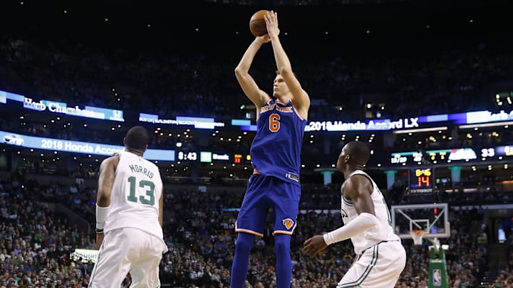 Jan 31, 2018; Boston, MA, USA; New York Knicks forward Kristaps Porzingis (6) shoots over Boston Celtics forward Marcus Morris (13) during the second quarter at TD Garden. Mandatory Credit: Winslow Townson-Imagn Images