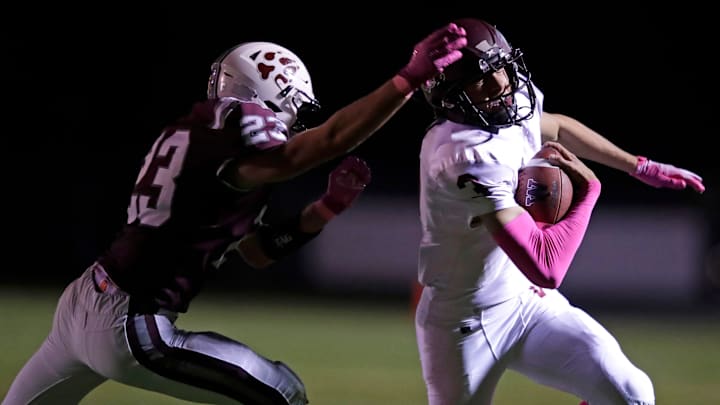 Fox Valley Lutheran High School's David Schumacher (23) tackles Winneconne High School's Brody Schaffer (3) during their football game Thursday, October 10, 2024, in Appleton, Wisconsin. Winneconne won 35-19.
