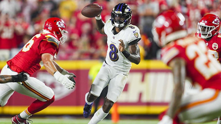 Sep 5, 2024; Kansas City, Missouri, USA; Baltimore Ravens quarterback Lamar Jackson (8) looks to pass against Kansas City Chiefs defensive end George Karlaftis (56) during the first half at GEHA Field at Arrowhead Stadium. Mandatory Credit: Jay Biggerstaff-Imagn Images