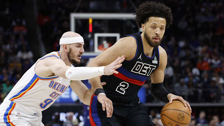 Mar 15, 2025; Detroit, Michigan, USA;  Detroit Pistons guard Cade Cunningham (2) dribbles on Oklahoma City Thunder guard Alex Caruso (9) in the first half at Little Caesars Arena. Mandatory Credit: Rick Osentoski-Imagn Images