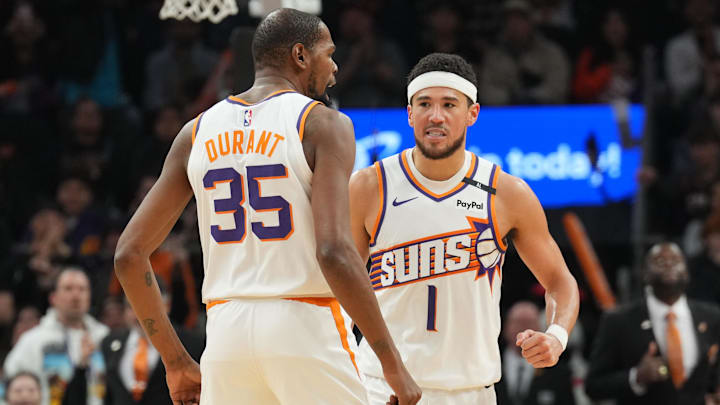 Jan 27, 2025; Phoenix, Arizona, USA; Phoenix Suns forward Kevin Durant (35) and Phoenix Suns guard Devin Booker (1) celebrate against the LA Clippers during the second half at Footprint Center. Mandatory Credit: Joe Camporeale-Imagn Images