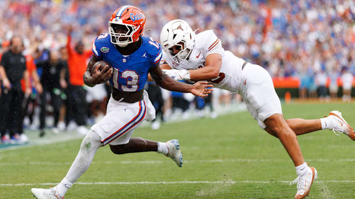 Oct 4, 2025; Gainesville, Florida, USA; Florida Gators running back Jadan Baugh (13) breaks a tackle from Texas Longhorns linebacker Liona Lefau (18) during the first half at Ben Hill Griffin Stadium. Mandatory Credit: Matt Pendleton-Imagn Images Oct 4, 2025; Gainesville, Florida, USA; Florida Gators running back Jadan Baugh (13) breaks a tackle from Texas Longhorns linebacker Liona Lefau (18) during the first half at Ben Hill Griffin Stadium. Mandatory Credit: Matt Pendleton-Imagn Images