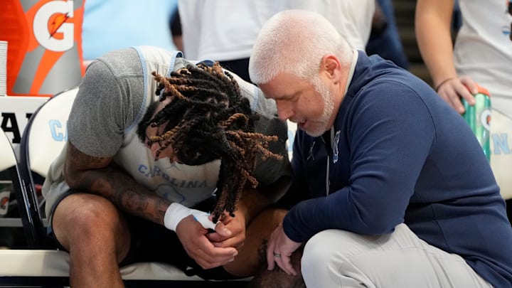 Oct 12, 2024; Cherokee, NC, USA;  Mandatory Credit:North Carolina Tar Heels guard RJ Davis (4) with the trainer on the bench in the second half at the Dean E. Smith Center. Bob Donnan-Imagn Images