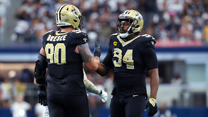 Sep 15, 2024; Arlington, Texas, USA; New Orleans Saints defensive end Cameron Jordan (94) celebrates with New Orleans Saints defensive tackle Bryan Bresee (90) during the second half against the Dallas Cowboys at AT&T Stadium. Mandatory Credit: Kevin Jairaj-Imagn Images