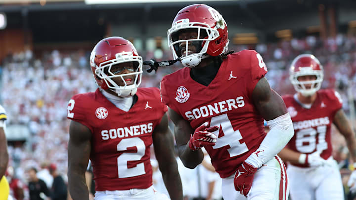 Sep 6, 2025; Norman, Oklahoma, USA; Oklahoma Sooners wide receiver Deion Burks (4) celebtrates with running back Jovantae Barnes (2) after scoring a touchdown against the Michigan Wolverines during the first half at Gaylord Family-Oklahoma Memorial Stadium. Mandatory Credit: Kevin Jairaj-Imagn Images