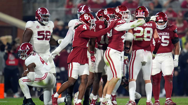 Oklahoma Sooners defensive lineman Ethan Downs (40) and defensive back Dez Malone (4) celebrate after bringing down Alabama Crimson Tide quarterback Jalen Milroe (4) during a college football game between the University of Oklahoma Sooners (OU) and the Alabama Crimson Tide at Gaylord Family - Oklahoma Memorial Stadium in Norman, Okla., Saturday, Nov. 23, 2024. Oklahoma won 24-3.