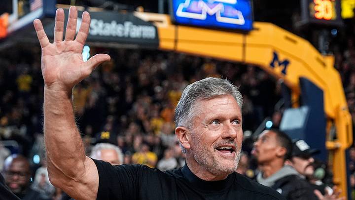 Michigan football head coach Kyle Whittingham waves at the crowd as he is being introduced on the floor during the first half between Michigan and USC at Crisler Center in Ann Arbor on Friday, Jan. 2, 2026.