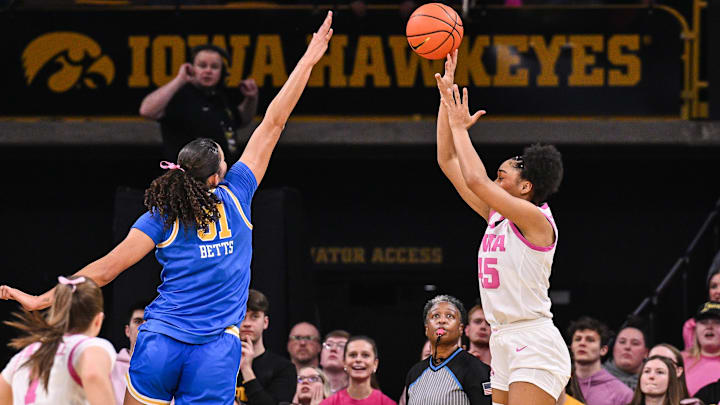 Feb 23, 2025; Iowa City, Iowa, USA; Iowa Hawkeyes forward Hannah Stuelke (45) shoots the ball over UCLA Bruins center Lauren Betts (51) during the second quarter at Carver-Hawkeye Arena. Mandatory Credit: Jeffrey Becker-Imagn Images