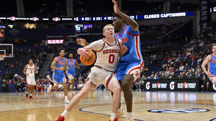 Mar 12, 2026; Nashville, TN, USA;  Georgia Bulldogs guard Blue Cain (0) dribbles into the chest of Mississippi Rebels forward Malik Dia (0) during the first half at Bridgestone Arena. Mandatory Credit: Steve Roberts-Imagn Images