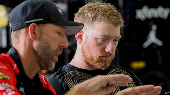 Billy Scott (left), crew chief for the No. 45 23XI Racing team, talks with Tyler Reddick in the Indianapolis Motor Speedway garage earlier this season. Billy Scott (left), crew chief for the No. 45 23XI Racing team, talks with Tyler Reddick in the Indianapolis Motor Speedway garage earlier this season.