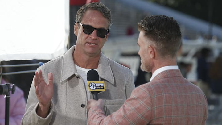 Nov 28, 2025; Starkville, Mississippi, USA; Mississippi Rebels head coach Lane Kiffin speaks with ESPN reporter Marty Smith before the game against the Mississippi State Bulldogs at Davis Wade Stadium at Scott Field. Mandatory Credit: Petre Thomas-Imagn Images