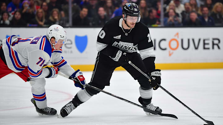 Mar 25, 2025; Los Angeles, California, USA; Los Angeles Kings left wing Tanner Jeannot (10) moves the puck against New York Rangers center Juuso Parssinen (71) during the second period at Crypto.com Arena. Mandatory Credit: Gary A. Vasquez-Imagn Images