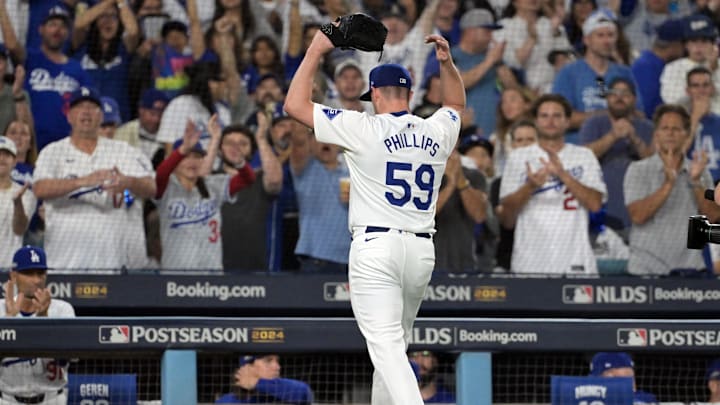 Oct 11, 2024; Los Angeles, California, USA; Los Angeles Dodgers pitcher Evan Phillips (59) reacts after being relieved in the seventh inning against the San Diego Padres during game five of the NLDS for the 2024 MLB Playoffs at Dodger Stadium. Mandatory Credit: Jayne Kamin-Oncea-Imagn Images Oct 11, 2024; Los Angeles, California, USA; Los Angeles Dodgers pitcher Evan Phillips (59) reacts after being relieved in the seventh inning against the San Diego Padres during game five of the NLDS for the 2024 MLB Playoffs at Dodger Stadium. Mandatory Credit: Jayne Kamin-Oncea-Imagn Images