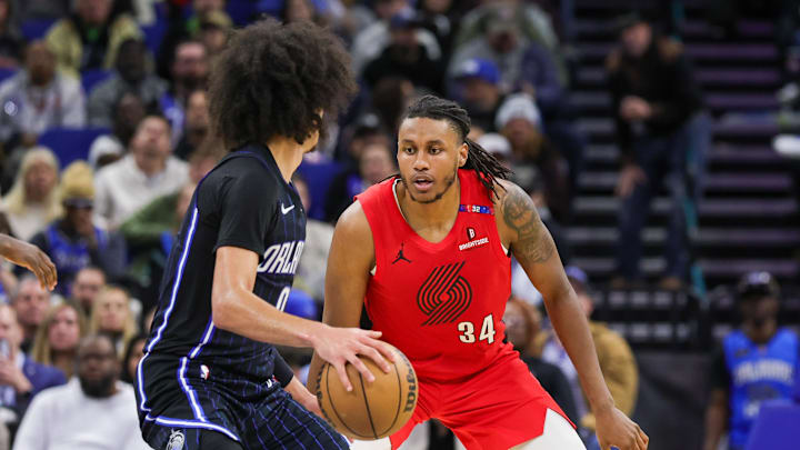 Jan 23, 2025; Orlando, Florida, USA; Portland Trail Blazers forward Jabari Walker (34) defends Orlando Magic guard Anthony Black (0) during the second half at Kia Center. Mandatory Credit: Mike Watters-Imagn Images
