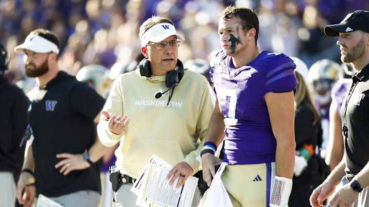 UW coach Jedd Fisch talks with quarterback Will Rogers during the Northwestern game on a sunny day.  