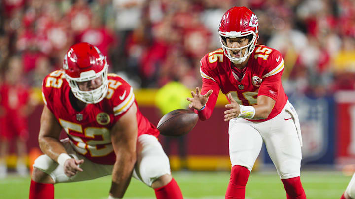 Sep 5, 2024; Kansas City, Missouri, USA; Kansas City Chiefs starting quarterback Patrick Mahomes (15) takes the snap from center Creed Humphrey (52) during the second half against the Baltimore Ravens at GEHA Field at Arrowhead Stadium. Mandatory Credit: Jay Biggerstaff-Imagn Images