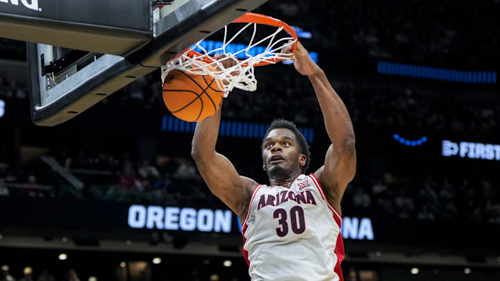 Mar 23, 2025; Seattle, WA, USA;  Arizona Wildcats forward Tobe Awaka (30) dunks the ball against the Oregon Ducks in the first half at Climate Pledge Arena. Mandatory Credit: Stephen Brashear-Imagn Images