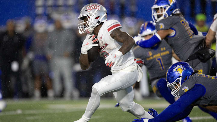 UNLV Rebels running back Jai'Den Thomas (9) looks for running room against the San Jose State Spartans during the second quarter at CEFCU Stadium.