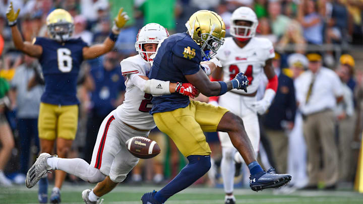 Sep 21, 2024; South Bend, Indiana, USA; Notre Dame Fighting Irish running back Jeremiyah Love (4) loses the ball as he crossed the goal line for a touchdown while Miami Redhawks safety Silas Walters (29) defends in the third quarter at Notre Dame Stadium. Mandatory Credit: Matt Cashore-Imagn Images Sep 21, 2024; South Bend, Indiana, USA; Notre Dame Fighting Irish running back Jeremiyah Love (4) loses the ball as he crossed the goal line for a touchdown while Miami Redhawks safety Silas Walters (29) defends in the third quarter at Notre Dame Stadium. Mandatory Credit: Matt Cashore-Imagn Images