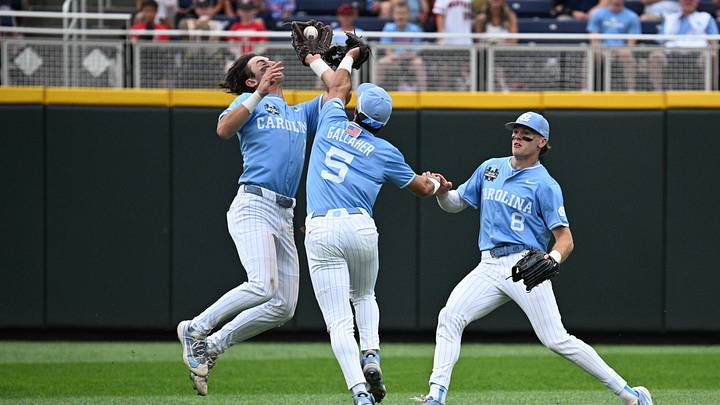 Jun 20, 2026; Omaha, NE, USA; North Carolina Tar Heels shortstop Jake Schaffner (2) collides with second baseman Gavin Gallaher (5) attempting to catch a ball as center fielder Owen Hull (8) looks on during a play that was ruled a double for the Oklahoma Sooners during the second inning at Charles Schwab Field. Mandatory Credit: Steven Branscombe-Imagn Images
