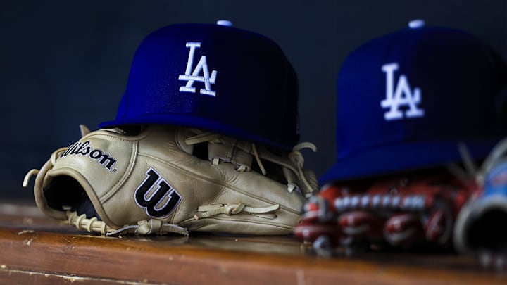Jul 30, 2025; Cincinnati, Ohio, USA; A general view of a Los Angeles Dodgers hat and glove during the second inning in the game against the Cincinnati Reds at Great American Ball Park. Mandatory Credit: Katie Stratman-Imagn Images Jul 30, 2025; Cincinnati, Ohio, USA; A general view of a Los Angeles Dodgers hat and glove during the second inning in the game against the Cincinnati Reds at Great American Ball Park. Mandatory Credit: Katie Stratman-Imagn Images