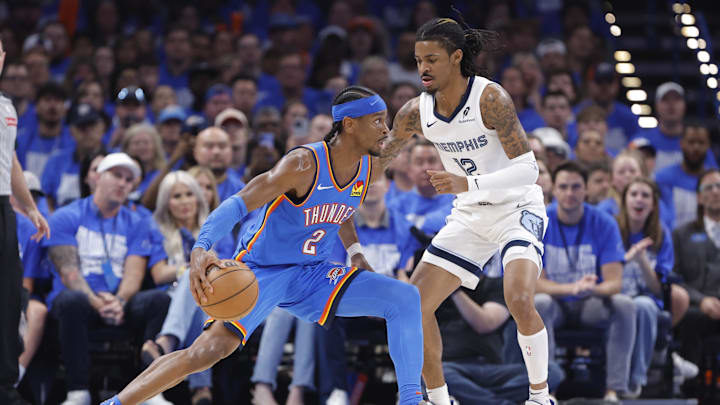 Apr 22, 2025; Oklahoma City, Oklahoma, USA; Oklahoma City Thunder guard Shai Gilgeous-Alexander (2) drives to the basket as Memphis Grizzlies guard Ja Morant (12) defends in the third quarter during game two of first round for the 2024 NBA Playoffs at Paycom Center. Mandatory Credit: Alonzo Adams-Imagn Images Apr 22, 2025; Oklahoma City, Oklahoma, USA; Oklahoma City Thunder guard Shai Gilgeous-Alexander (2) drives to the basket as Memphis Grizzlies guard Ja Morant (12) defends in the third quarter during game two of first round for the 2024 NBA Playoffs at Paycom Center. Mandatory Credit: Alonzo Adams-Imagn Images
