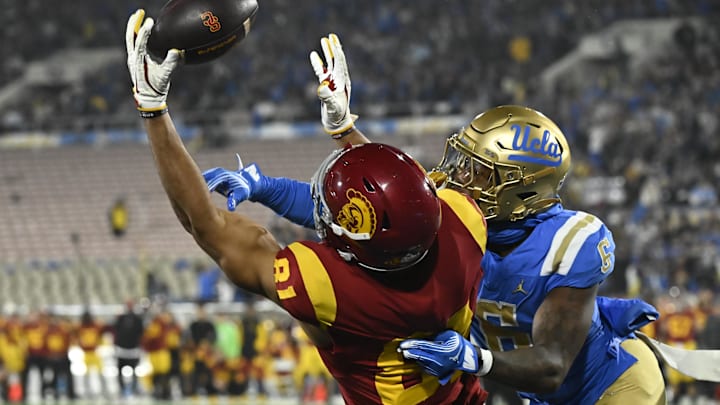 Nov 23, 2024; Pasadena, California, USA; USC Trojans wide receiver Kyle Ford (81) and UCLA Bruins defensive back Jaylin Davies (6) battle for an incomplete pass in the end zone during the second quarter at Rose Bowl. Mandatory Credit: Robert Hanashiro-Imagn Images Nov 23, 2024; Pasadena, California, USA; USC Trojans wide receiver Kyle Ford (81) and UCLA Bruins defensive back Jaylin Davies (6) battle for an incomplete pass in the end zone during the second quarter at Rose Bowl. Mandatory Credit: Robert Hanashiro-Imagn Images