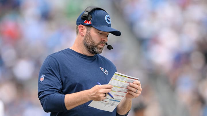 Sep 15, 2024; Nashville, Tennessee, USA;  Tennessee Titans head coach Brian Callahan looks at his play sheet against the New York Jets during the first half at Nissan Stadium. Mandatory Credit: Steve Roberts-Imagn Images