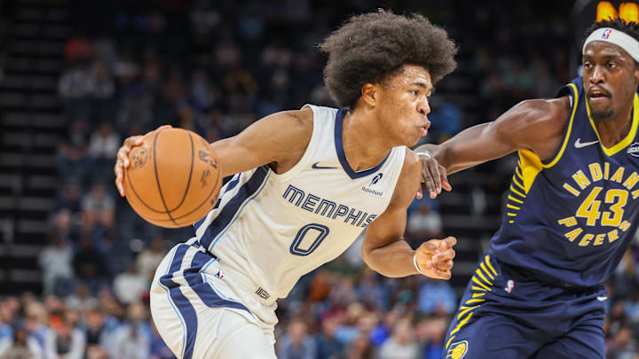 Oct 25, 2025; Memphis, Tennessee, USA; Memphis Grizzlies forward Jaylen Wells (0) drives against Indiana Pacers forward Pascal Siakam (43) during the first half at FedExForum. Mandatory Credit: Wesley Hale-Imagn Images