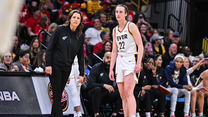 May 4, 2025; Iowa City, IA, USA; Indiana Fever guard Caitlin Clark (22) looks on with head coach Stephanie White during the third quarter against the Brazil National Team at Carver-Haweye Arena. Mandatory Credit: Jeffrey Becker-Imagn Images
